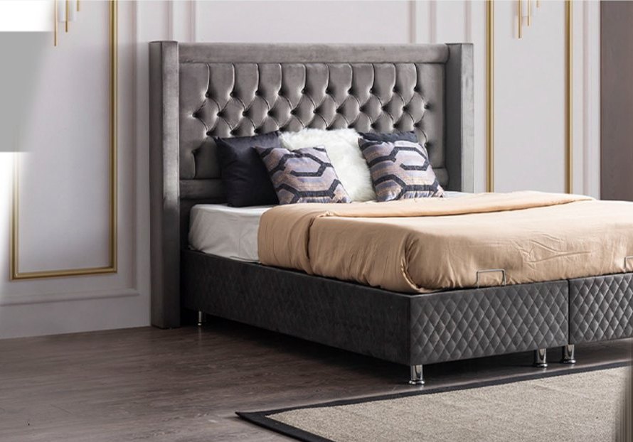 Grey tufted box spring in a classic bedroom